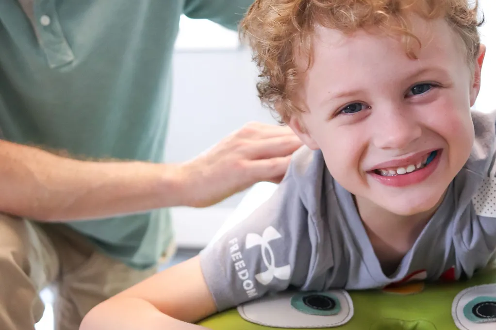 Child receiving comfortable chiropractic care.