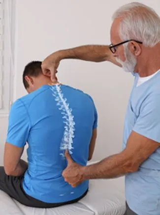 Back examination focusing on spinal alignment.
