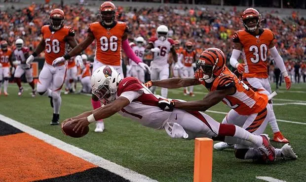 Football player tackled mid-air, highlighting sports chiropractic care.