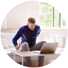 Adult dealing with back pain while sitting.