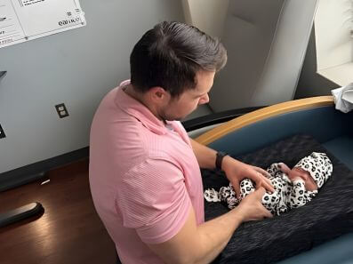 pediatric chiropractor giving gentle adjustment to a child for healthy growth