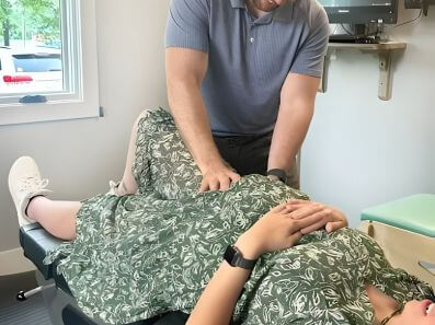 pregnant woman receiving gentle prenatal chiropractic adjustment