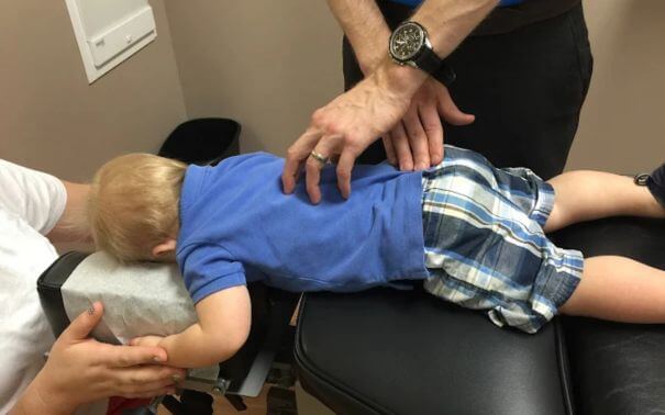 Chiropractor performing a gentle adjustment for a patient