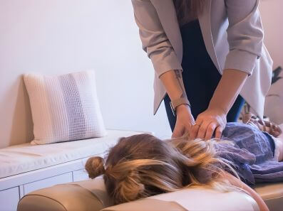 Chiropractor evaluating spinal alignment for back pain