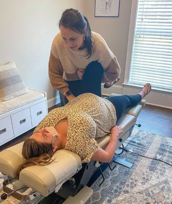 Pregnant woman receiving a gentle prenatal chiropractic adjustment for back and hip comfort