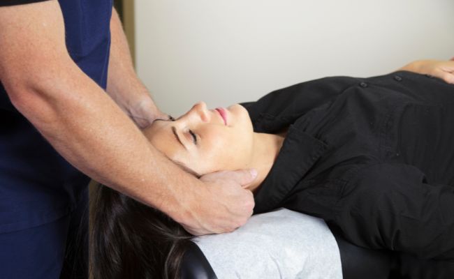 Chiropractor performing a neck adjustment